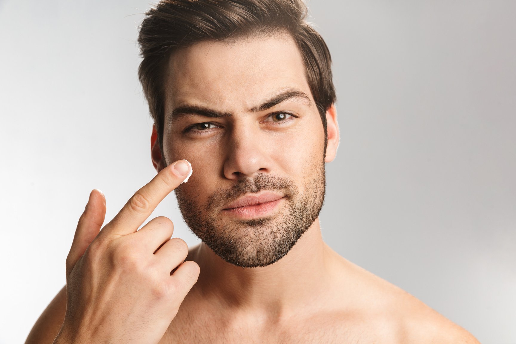 Handsome Man Applying Facial Cream