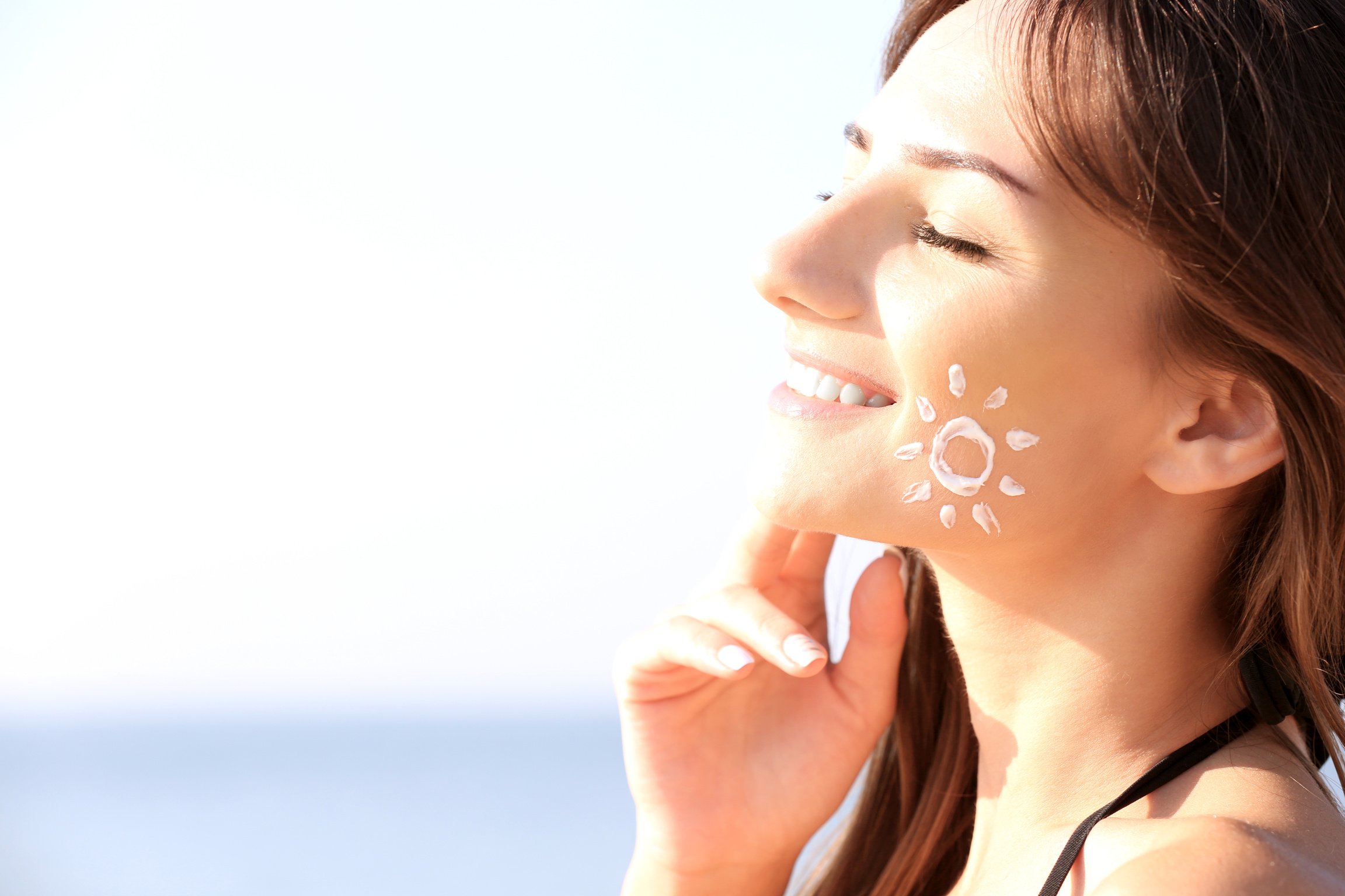 Young Woman with Sunscreen on Face