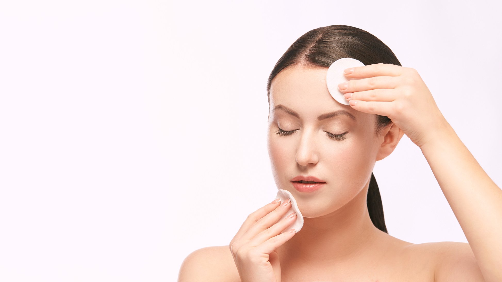 Woman Removing Her Makeup with Cotton Pads Copy Space